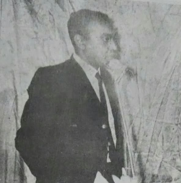 Grayscale portrait of a man in a suit